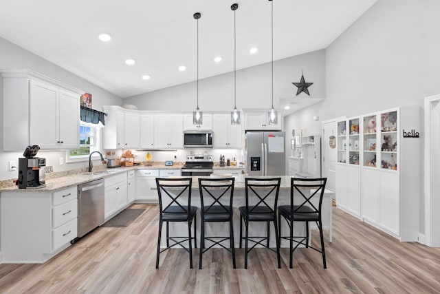 116 Hackberry Ct, Frankfort, KY 40601 - kitchen with stainless steel appliances, a sink, a kitchen breakfast bar, white cabinetry, and light wood-type flooring