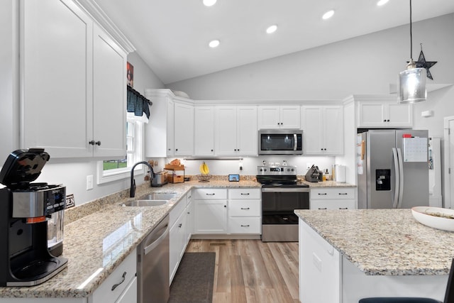 116 Hackberry Ct, Frankfort, KY 40601 - kitchen featuring appliances with stainless steel finishes, a sink, lofted ceiling, light wood-style floors, and white cabinetry