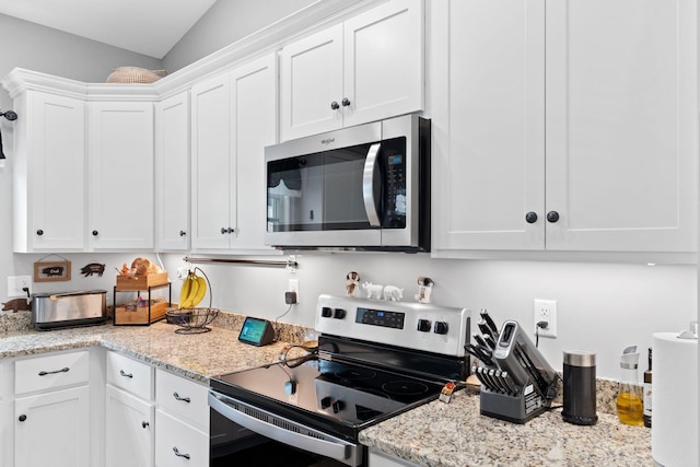116 Hackberry Ct, Frankfort, KY 40601 - kitchen with stainless steel appliances, white cabinets, light stone countertops, and lofted ceiling