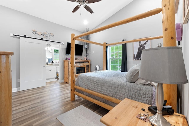 116 Hackberry Ct, Frankfort, KY 40601 - bedroom featuring vaulted ceiling, a barn door, wood finished floors, ensuite bath, and a fireplace