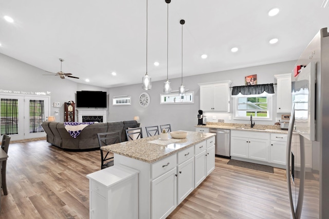 116 Hackberry Ct, Frankfort, KY 40601 - kitchen with appliances with stainless steel finishes, a kitchen island, a ceiling fan, light wood-style flooring, and a sink