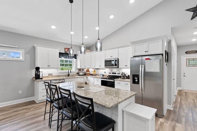 116 Hackberry Ct, Frankfort, KY 40601 - kitchen with appliances with stainless steel finishes, a sink, a kitchen breakfast bar, white cabinets, and high vaulted ceiling