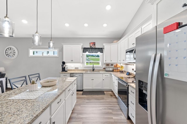 116 Hackberry Ct, Frankfort, KY 40601 - kitchen featuring appliances with stainless steel finishes, a sink, white cabinets, light wood finished floors, and pendant lighting