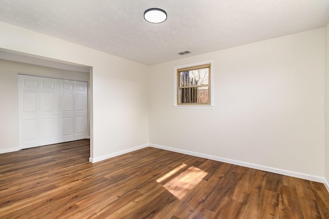 2837 Yellowstone Pkwy, Lexington, KY 40517 - unfurnished bedroom with baseboards, wood finished floors, a closet, and a textured ceiling
