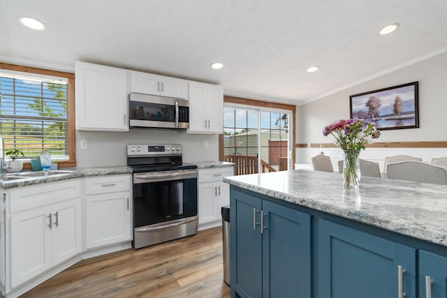 460 Keller Ln, Science Hill, KY 42553 - kitchen with stainless steel appliances, recessed lighting, light wood finished floors, white cabinets, and a sink