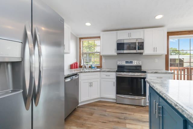 460 Keller Ln, Science Hill, KY 42553 - kitchen featuring stainless steel appliances, a sink, healthy amount of natural light, white cabinets, and recessed lighting