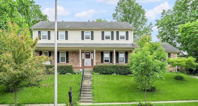 909 Witthuhn Way, Lexington, KY 40503 - view of front of property with a front lawn, covered porch, a chimney, and brick siding