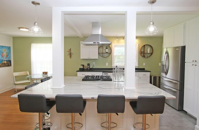 937 Mason Headley Rd, Lexington, KY 40504 - kitchen with appliances with stainless steel finishes, island range hood, white cabinets, and a breakfast bar area