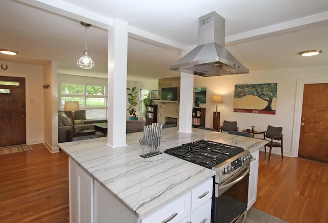 937 Mason Headley Rd, Lexington, KY 40504 - kitchen featuring island exhaust hood, stainless steel range with gas stovetop, open floor plan, white cabinets, and wood finished floors