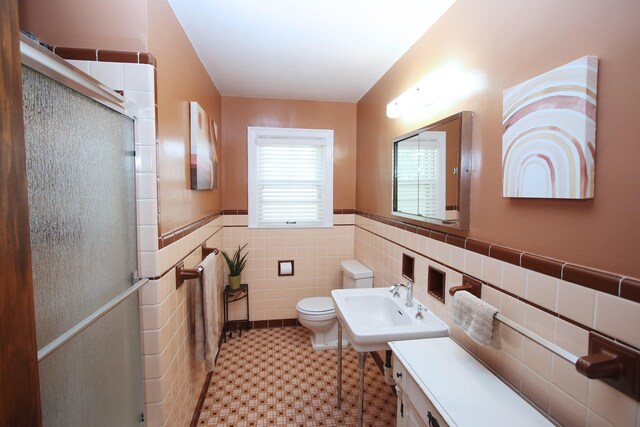 937 Mason Headley Rd, Lexington, KY 40504 - full bath featuring toilet, a shower stall, tile walls, a wainscoted wall, and a sink