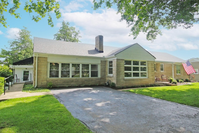 937 Mason Headley Rd, Lexington, KY 40504 - back of property with stone siding, a chimney, and a yard