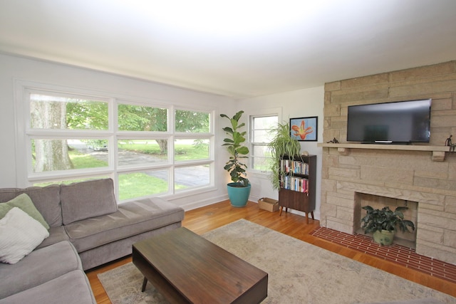 937 Mason Headley Rd, Lexington, KY 40504 - living area featuring wood finished floors, a stone fireplace, and baseboards