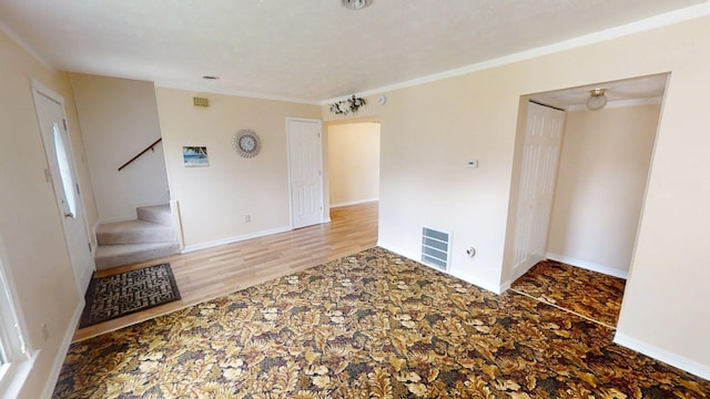 281 Osage Ct, Lexington, KY 40509 - unfurnished room with stairway, carpet flooring, crown molding, baseboards, and wood finished floors