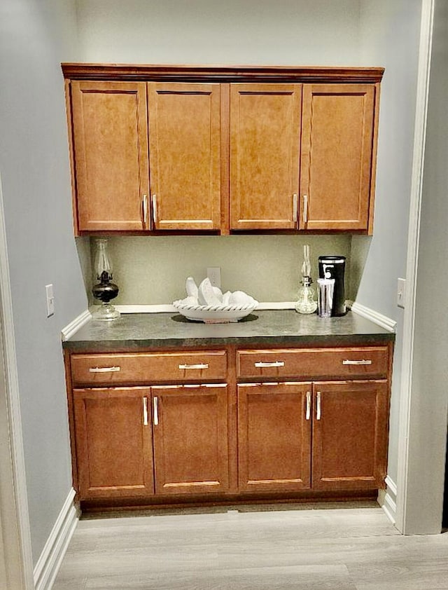 133 Mcintosh Park, Georgetown, KY 40324 - kitchen featuring dark countertops, light wood-type flooring, and brown cabinets