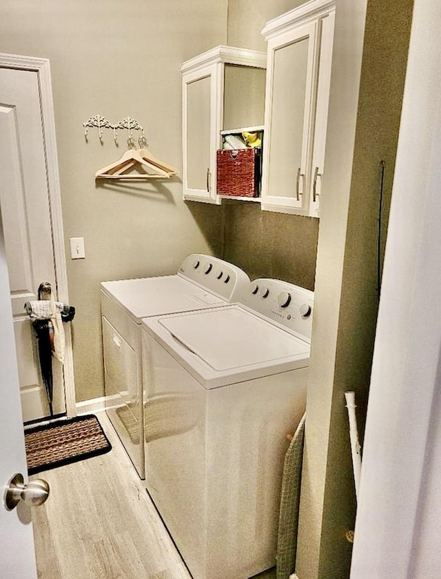 133 Mcintosh Park, Georgetown, KY 40324 - laundry area with washer and clothes dryer, cabinet space, and wood finished floors