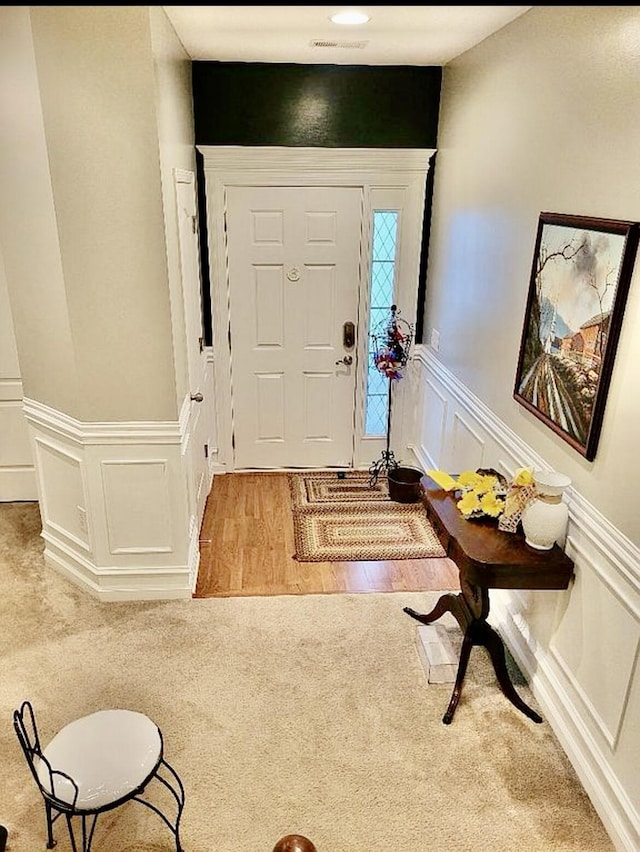 133 Mcintosh Park, Georgetown, KY 40324 - entryway featuring a decorative wall, carpet, a wainscoted wall, and wood finished floors
