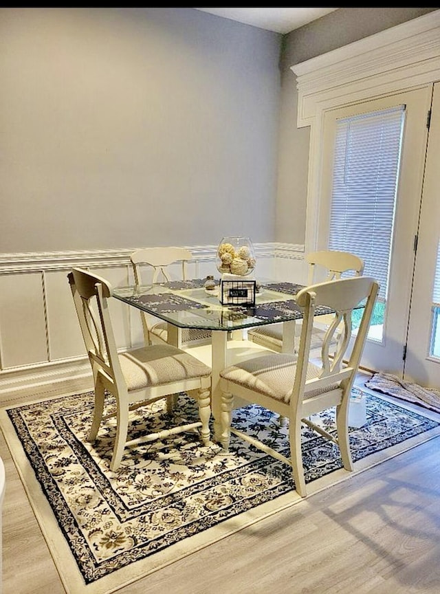 133 Mcintosh Park, Georgetown, KY 40324 - dining room featuring wood finished floors, wainscoting, and a decorative wall