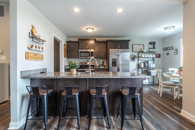 140 Central Park Ave, Berea, KY 40403 - kitchen featuring stainless steel appliances, dark brown cabinetry, dark wood finished floors, a sink, and stone countertops