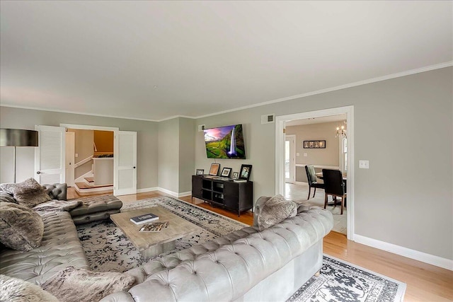 235 Westover Rd, Frankfort, KY 40601 - living room with light wood-type flooring, crown molding, baseboards, and a chandelier