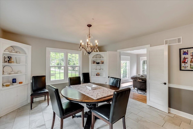 235 Westover Rd, Frankfort, KY 40601 - dining space featuring healthy amount of natural light, a chandelier, baseboards, and built in features