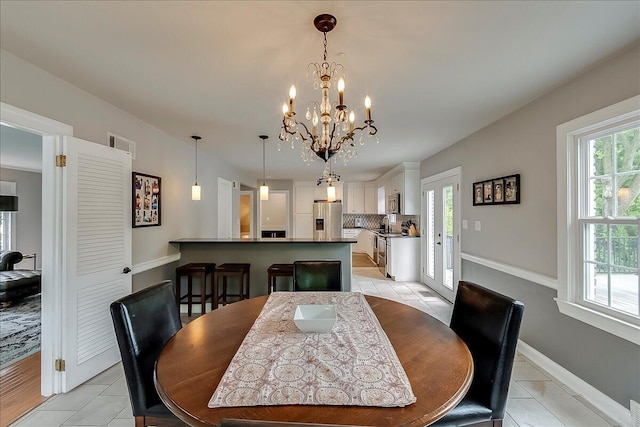 235 Westover Rd, Frankfort, KY 40601 - dining room with a chandelier, baseboards, and light tile patterned floors