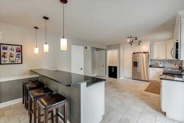235 Westover Rd, Frankfort, KY 40601 - kitchen featuring stainless steel appliances, dark countertops, tasteful backsplash, a breakfast bar, and a sink