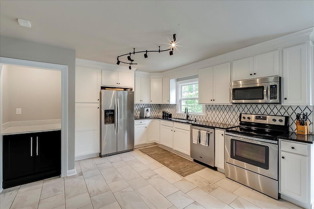 235 Westover Rd, Frankfort, KY 40601 - kitchen with stainless steel appliances, dark countertops, a sink, white cabinets, and tasteful backsplash