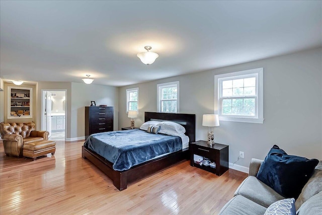 235 Westover Rd, Frankfort, KY 40601 - bedroom featuring light wood-type flooring, baseboards, and connected bathroom