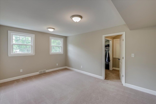 235 Westover Rd, Frankfort, KY 40601 - unfurnished bedroom with light carpet, a spacious closet, baseboards, and a closet