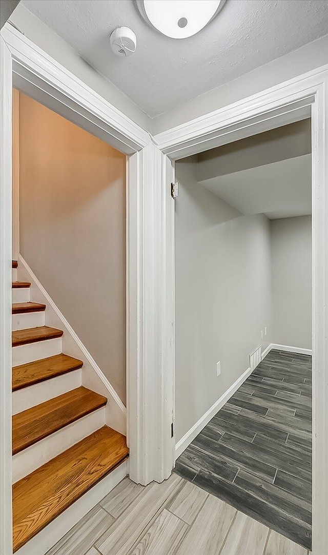 235 Westover Rd, Frankfort, KY 40601 - below grade area with wood finish floors, stairs, and baseboards
