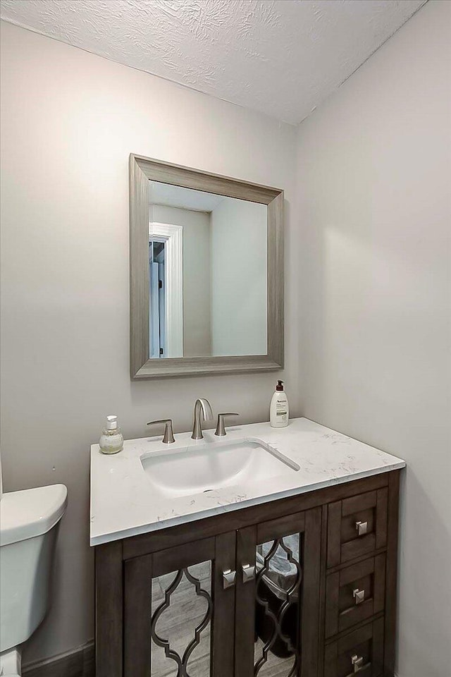 235 Westover Rd, Frankfort, KY 40601 - half bathroom featuring vanity, toilet, and a textured ceiling
