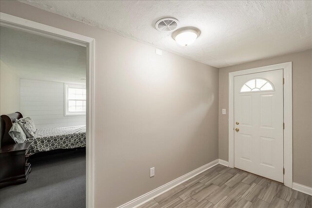 235 Westover Rd, Frankfort, KY 40601 - entrance foyer featuring a textured ceiling, light wood-style flooring, and baseboards