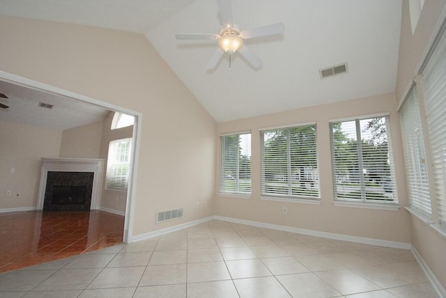 102 Academy Dr, Wilmore, KY 40390 - spare room featuring ceiling fan, plenty of natural light, tile patterned floors, a premium fireplace, and high vaulted ceiling