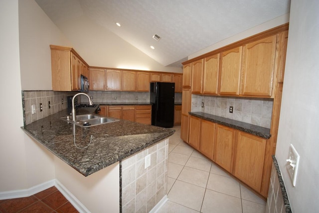 102 Academy Dr, Wilmore, KY 40390 - kitchen with freestanding refrigerator, light tile patterned flooring, vaulted ceiling, a sink, and tasteful backsplash