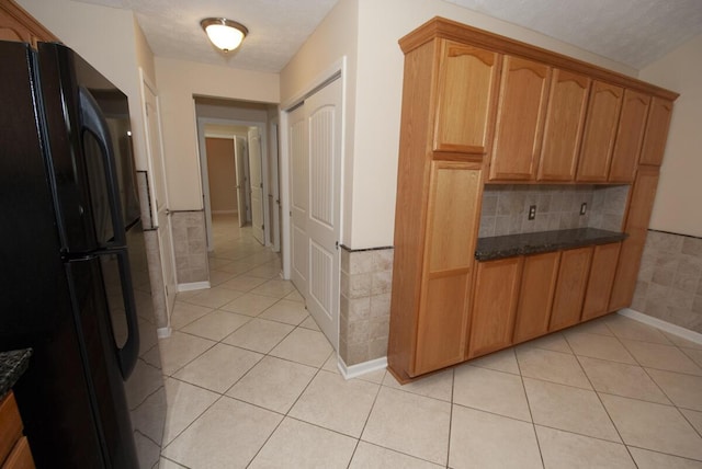 102 Academy Dr, Wilmore, KY 40390 - kitchen with freestanding refrigerator, light tile patterned flooring, backsplash, and dark stone countertops