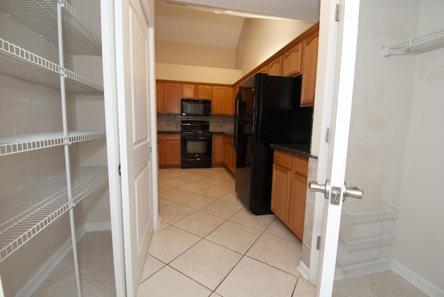 102 Academy Dr, Wilmore, KY 40390 - kitchen featuring black appliances, dark countertops, light tile patterned flooring, baseboards, and decorative backsplash