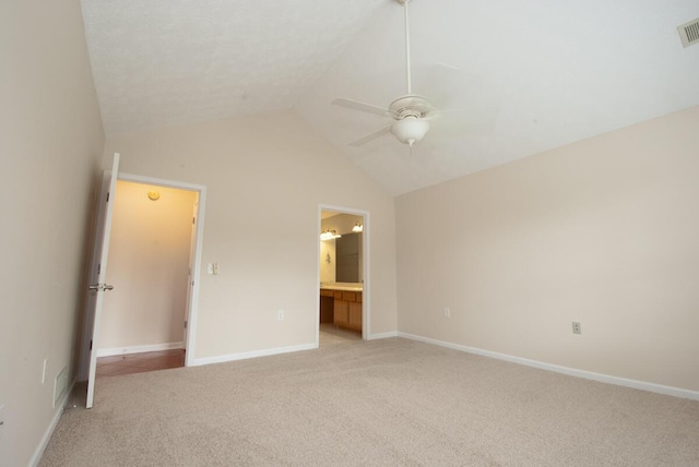 102 Academy Dr, Wilmore, KY 40390 - unfurnished bedroom featuring light carpet, vaulted ceiling, ensuite bathroom, ceiling fan, and baseboards