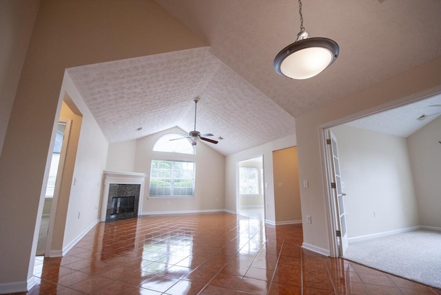 102 Academy Dr, Wilmore, KY 40390 - unfurnished living room featuring tile patterned flooring, ceiling fan, a high end fireplace, lofted ceiling, and baseboards
