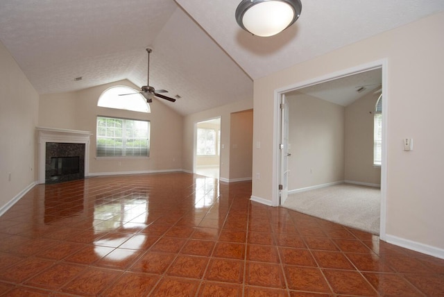102 Academy Dr, Wilmore, KY 40390 - unfurnished living room with tile patterned flooring, lofted ceiling, a ceiling fan, baseboards, and a premium fireplace