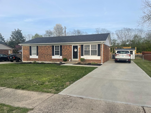 310 Yorktown Dr, Paris, KY 40361 - ranch-style house featuring brick siding, a front yard, concrete driveway, and roof with shingles