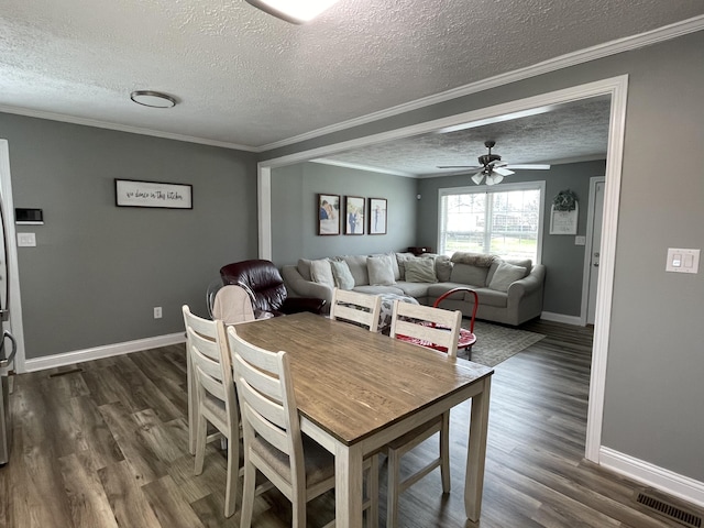 310 Yorktown Dr, Paris, KY 40361 - dining area featuring a textured ceiling, baseboards, crown molding, dark wood-type flooring, and a ceiling fan