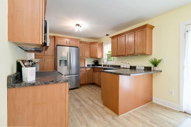 913 W 8th St, Corbin, KY 40701 - kitchen featuring stainless steel fridge, a peninsula, light wood-style floors, and pendant lighting