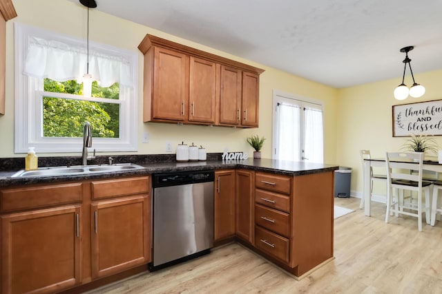 913 W 8th St, Corbin, KY 40701 - kitchen with stainless steel dishwasher, a sink, a peninsula, brown cabinetry, and light wood-style flooring