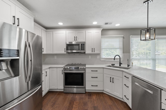 1109 Seville Ct, Lexington, KY 40515 - kitchen with stainless steel appliances, a sink, light countertops, dark wood-type flooring, and white cabinetry