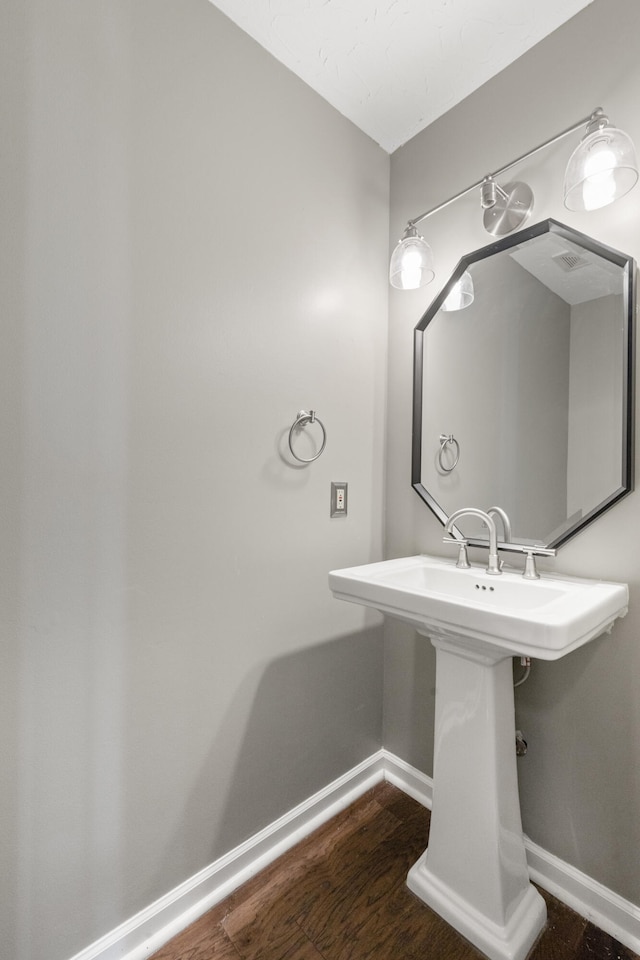 1109 Seville Ct, Lexington, KY 40515 - bathroom featuring baseboards, wood finished floors, and a sink