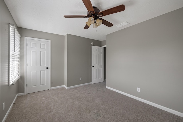 1109 Seville Ct, Lexington, KY 40515 - unfurnished bedroom featuring carpet, baseboards, multiple windows, and a ceiling fan