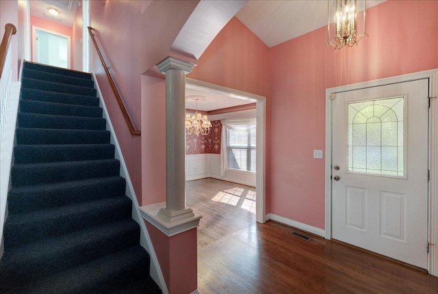 3373 Malone Dr, Lexington, KY 40513 - entrance foyer with a chandelier, stairway, a wainscoted wall, wood finished floors, and decorative columns