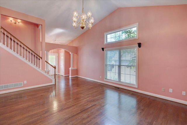 3373 Malone Dr, Lexington, KY 40513 - unfurnished living room with arched walkways, wood finished floors, stairs, plenty of natural light, and high vaulted ceiling