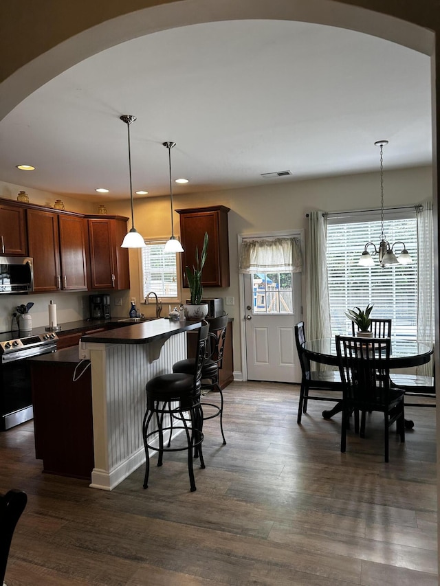203 Whitman Way, Georgetown, KY 40324 - kitchen featuring appliances with stainless steel finishes, arched walkways, dark countertops, recessed lighting, and dark wood finished floors