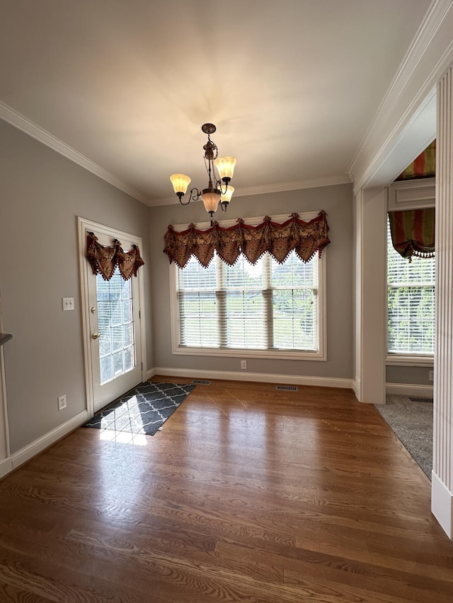 3217 Malone Dr, Lexington, KY 40513 - unfurnished dining area with a chandelier, crown molding, wood finished floors, and baseboards